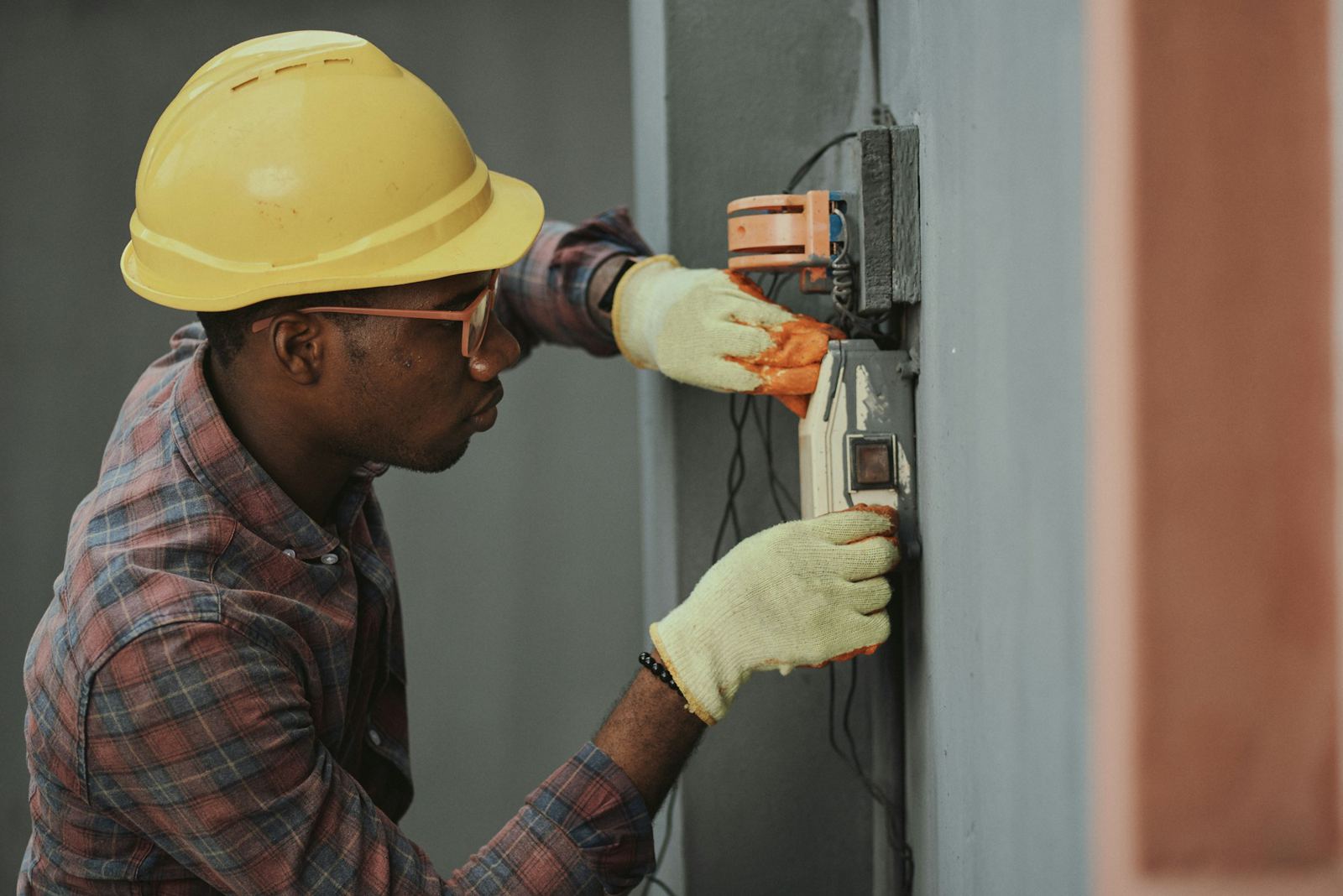 Worker wearing a hard hat and safety gloves