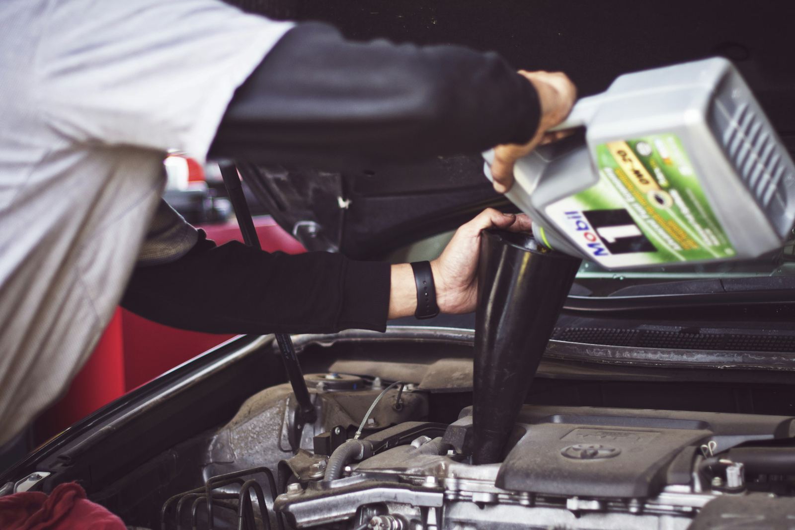 Engine oil being poured during a vehicle service